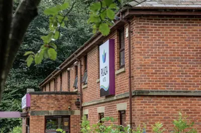 a brick building with a sign on the side of it at Plaza Hotel, Preston Lancashire, Sure Collection by Best Western in Chorley