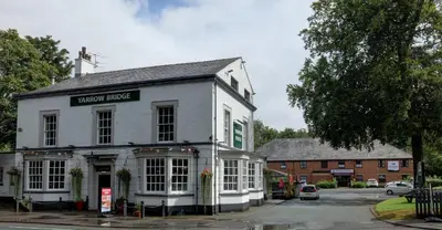 a white building with a sign for a town house at Plaza Hotel, Preston Lancashire, Sure Collection by Best Western in Chorley