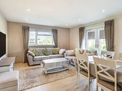 a living room with a couch and a table at Beeches Cottage in Blackburn
