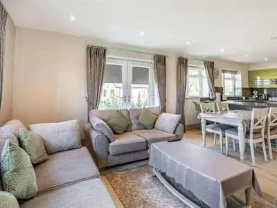 a living room with a couch and a table at Beeches Cottage in Blackburn