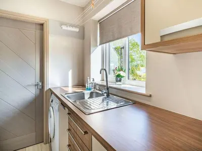 a kitchen with a sink and a window at Beeches Cottage in Blackburn