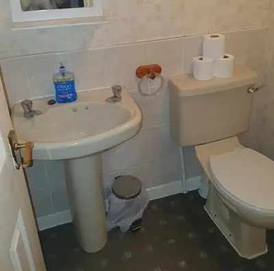 a bathroom with a white sink and a toilet at The Rutlands in Blackpool