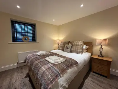 a bedroom with a bed with two towels on it at Innkeepers Cottage in Ulverston