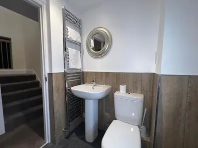 a bathroom with a toilet and a sink at Innkeepers Cottage in Ulverston