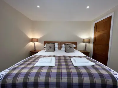 a bedroom with a bed with two towels on it at Innkeepers Cottage in Ulverston