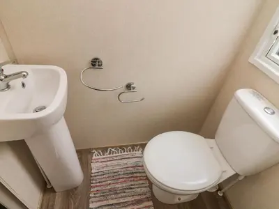 a bathroom with a white toilet and a sink at 12A Borwick Lakes in Carnforth