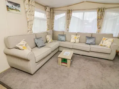 a living room with a couch and a coffee table at 12A Borwick Lakes in Carnforth