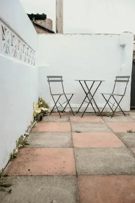 two chairs sitting next to a white wall at Quirky bohemian Lake District miners cottage- 6 bd in Millom