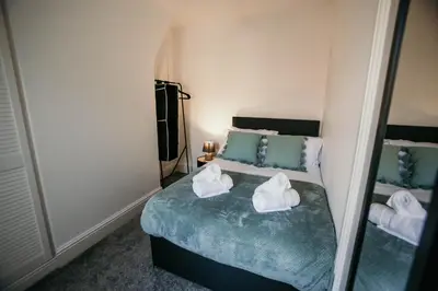 a bedroom with a bed with towels on it at PARKER St by Prestige Properties SA in Barrow in Furness