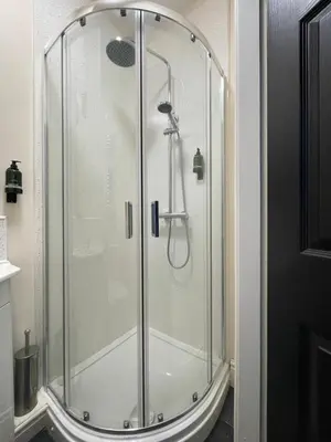 a shower with a glass enclosure in a bathroom at Dinorwic Lodge in Liverpool