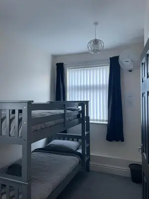 two bunk beds in a room with a window at Dinorwic Lodge in Liverpool