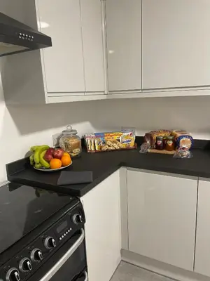 a kitchen counter with a plate of fruit and snacks at Dinorwic Lodge in Liverpool