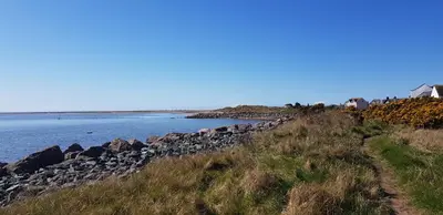 a rock retaining wall next to a body of water at Port Haverigg Marina Village in Millom