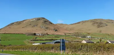 a hillside with a house and a mountain at Port Haverigg Marina Village in Millom