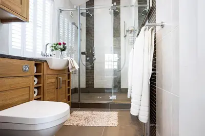 a bathroom with a shower and a toilet and a sink at Finest Retreats - Lighthouse Cottage in Rampside
