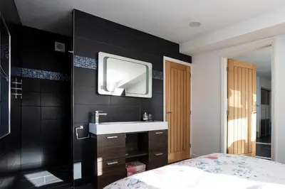 a bathroom with a sink and a tv on the wall at Finest Retreats - The Lighthouse Hide in Rampside