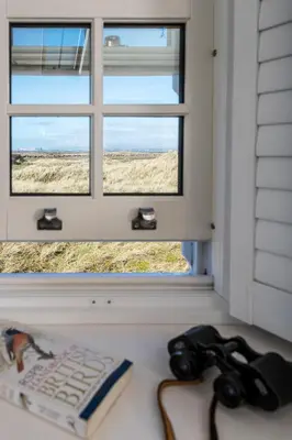 a window with a keyboard and a book on a table at Finest Retreats - Walney Island Lighthouse in Rampside