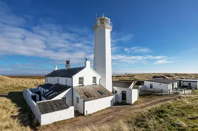 a lighthouse in the middle of a field at Finest Retreats - Walney Island Lighthouse in Rampside