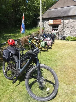 a group of bikes parked on the grass with a flag at Lile Cottage at Gleaston Water Mill in Ulverston