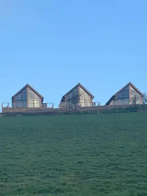 a group of three glass houses in a field at Valley View Lodge Sleeps 8 with Hot Tub in Preston
