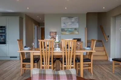 a dining room with a wooden table and chairs at Valley View Lodge Sleeps 8 with Hot Tub in Preston