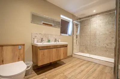 a bathroom with a toilet and a sink and a shower at Valley View Lodge Sleeps 8 with Hot Tub in Preston