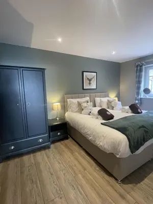 a bedroom with two beds and a blue wall at Valley View Lodge Sleeps 8 with Hot Tub in Preston
