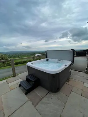 a bath tub sitting on top of a patio at Valley View Lodge Sleeps 8 with Hot Tub in Preston