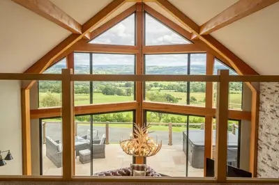 an open living room with a large window at Valley View Lodge Sleeps 8 with Hot Tub in Preston