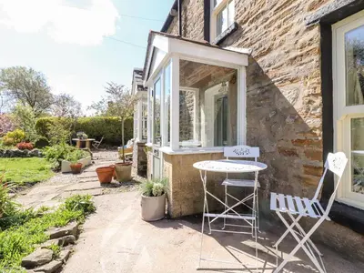 a table and two chairs outside of a house at Sunny Bank in Lancaster