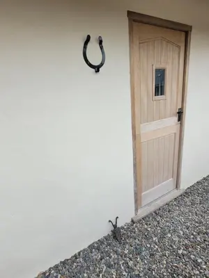 a door on the side of a white building at Swallow cottage, Over Kellet in Over Kellet