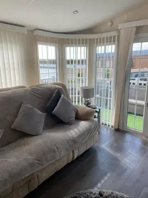 a living room with a couch with pillows on it at Port Haverigg Millom in Millom