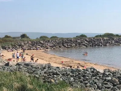 a group of people on a beach near the water at Port Haverigg Millom in Millom