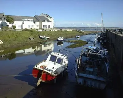 a group of boats docked in a body of water at Port Haverigg Millom in Millom