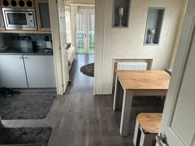 a small kitchen with a table and a microwave at Port Haverigg Millom in Millom
