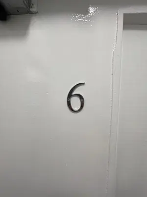 a metal door with the number six on it at County serviced accommodation in Liverpool