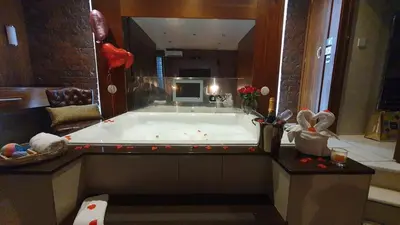 a large bath tub in a bathroom with a large mirror at Infinity PartyPadsLiverpool Hen and Stag Welcome in Liverpool