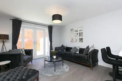 a living room with couches and a table at Stunning 2 Bedroom Apartment in Wallasey in Wallasey
