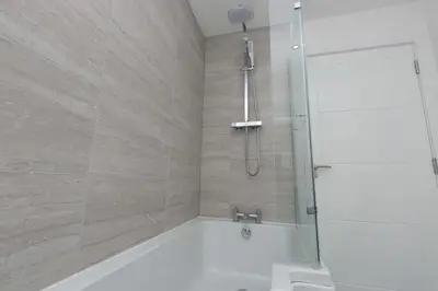 a bathroom with a shower with a bath tub at Stunning 2 Bedroom Apartment in Wallasey in Wallasey