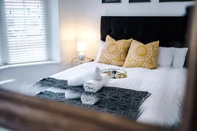 a bedroom with a bed with towels on it at Families Only - Pet Friendly sleeps 6 maximum NO PARTIES in Blackpool