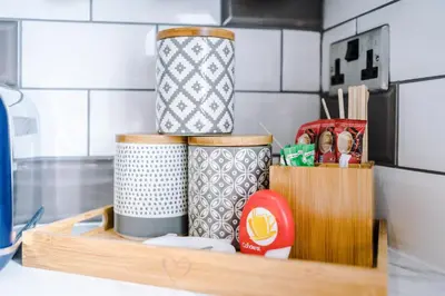 a wooden shelf with cups on top of a kitchen counter at Families Only - Pet Friendly sleeps 6 maximum NO PARTIES in Blackpool