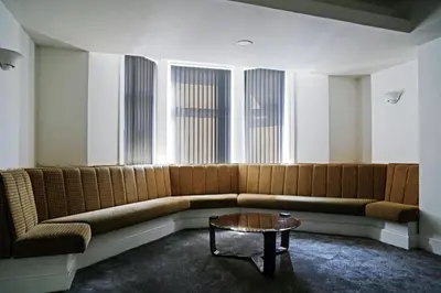 a large couch in a room with a table at High Tide Hotel Oyo in Blackpool