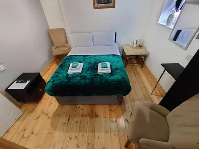 a small room with a bed and a couch at High Tide Hotel Oyo in Blackpool