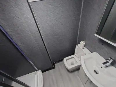 a small bathroom with a toilet and a sink at High Tide Hotel Oyo in Blackpool
