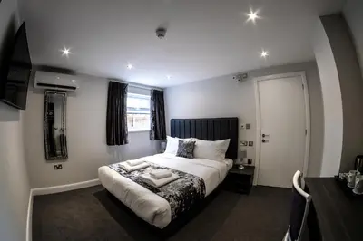 a bedroom with a bed and a television in it at Anelli Hotel in Southport
