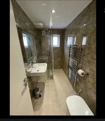 a bathroom with a sink and a shower and a toilet at Anelli Hotel in Southport