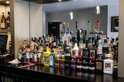 a bar filled with lots of bottles of alcohol at Anelli Hotel in Southport