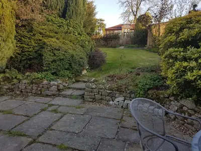 a bench sitting in the middle of a garden at Cottage - Sleeps 4 - Pets Ok - Garden - Parking in Carnforth