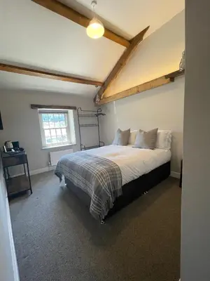 a bedroom with a bed and a window at The Tavern at Hale in Milnthorpe