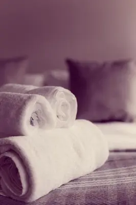 a pile of towels sitting on top of a bed at The Tavern at Hale in Milnthorpe